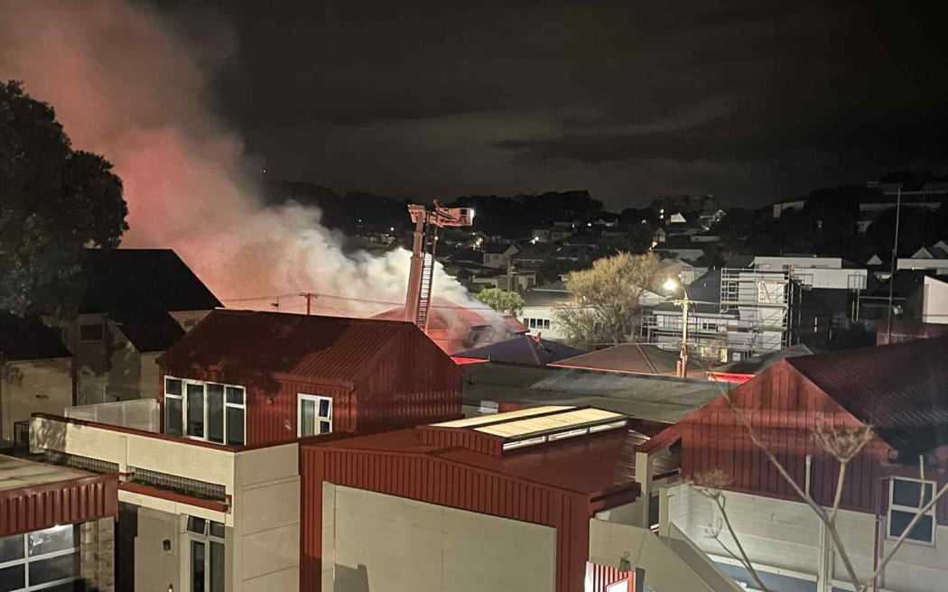 Smoke from the blaze drifts across the suburb.