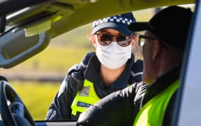 Police conduct roadside checks on the outskirts of Melbourne on July  9, 2020 on the first day of the citys new lockdown after an outbreak of the COVID-19 coronavirus.