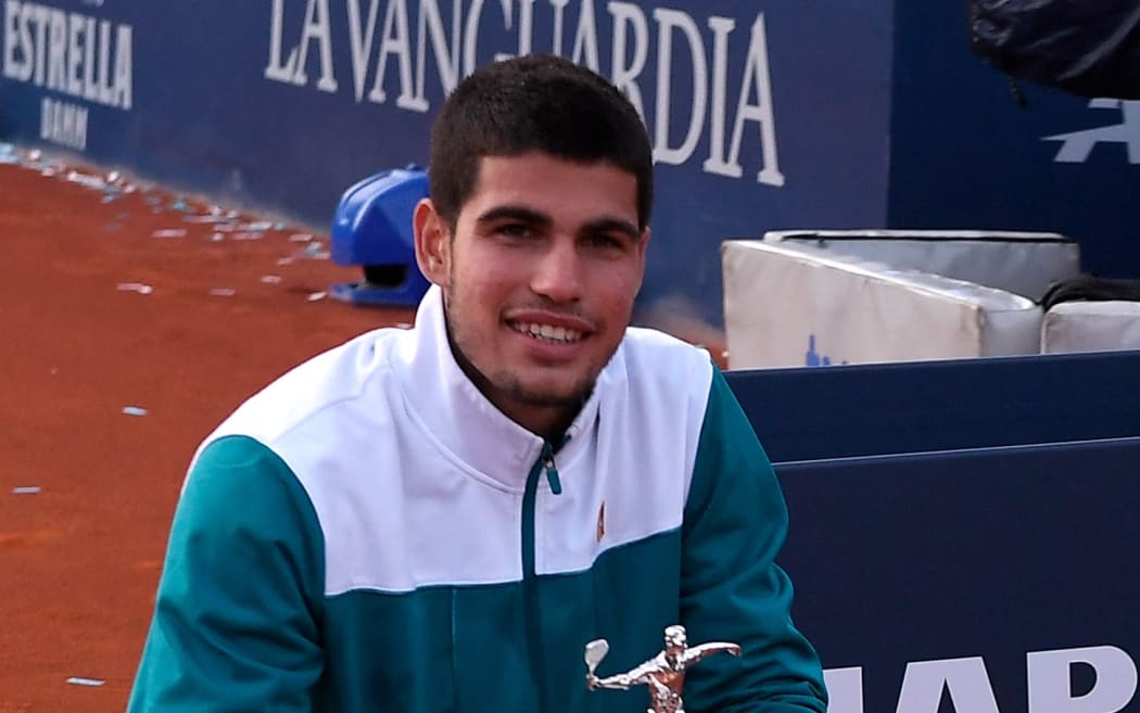 pain's Carlos Alcaraz poses with the trophy after winning against Spain's Pablo Carreno-Busta during the ATP Barcelona Open tennis tournament 24 April 2022