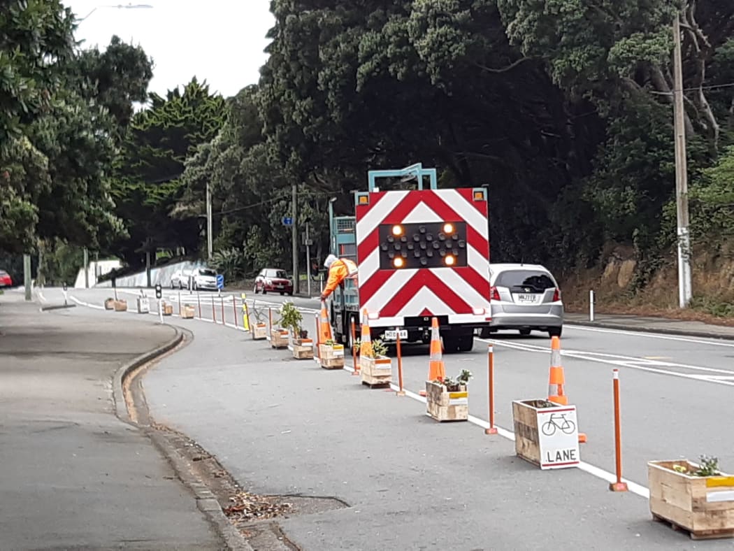 Council contractors remove a DIY protected cycle path in Berhampore, Wellington.