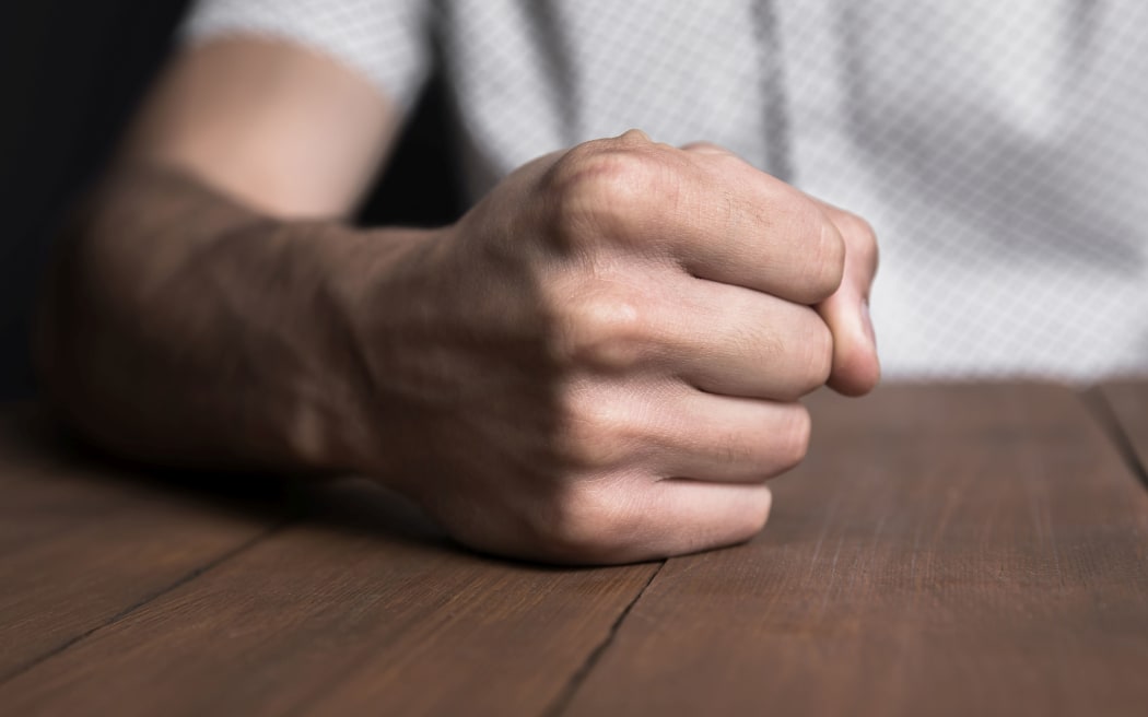 Man's fist suggesting violence or crime