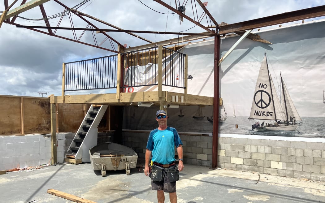 “Handy Andy” Handyman Andy Brown helping board up Bruce Howley’s shed. The mural on the wall has remained, but the roof hasn’t.