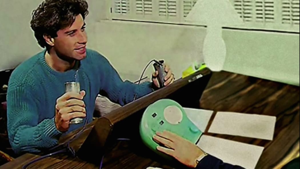 John Travolta holding the device used during auditing sessions