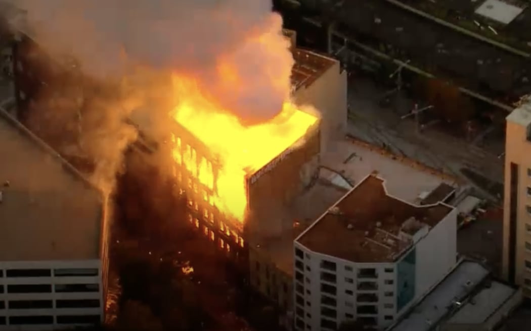 A building is on fire in downtown Sydney.
