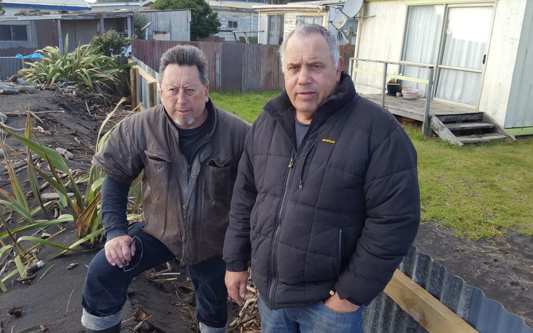 Trevor Dodunski and David Zimmerman survey the latest damage at East Beach, Waitara.