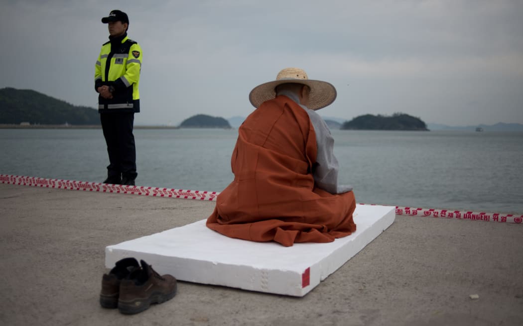 A monk offers prayers for victims of the Sewol ferry.