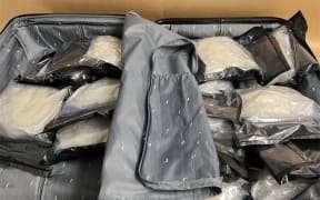 Suitcase containing 14 individually vacuum-sealed packages of methamphetamine.