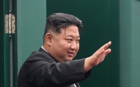 In this handout photograph taken and released by the Government of the Primorsky region on September 17, 2023, North Korea's leader Kim Jong Un waves before boarding a train during a farewell ceremony at the end of his visit to Russia at the Artyom railway station near Vladivostok, in the Primorsky region. (Photo by Handout / Government of Primorsky region / AFP) / RESTRICTED TO EDITORIAL USE - MANDATORY CREDIT "AFP PHOTO / Government of Primorsky region" - NO MARKETING NO ADVERTISING CAMPAIGNS - DISTRIBUTED AS A SERVICE TO CLIENTS