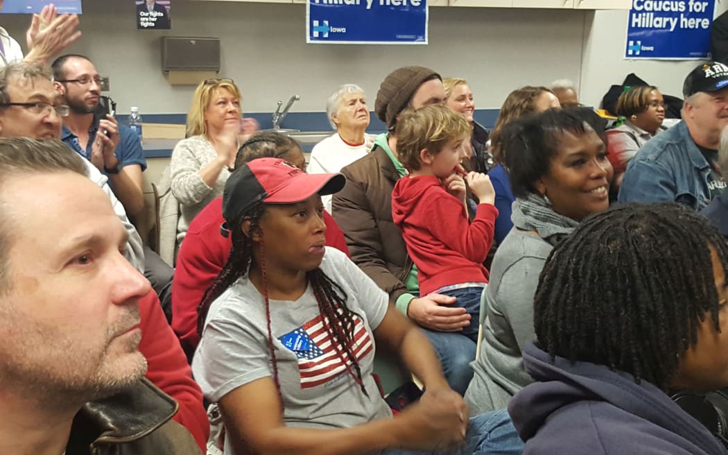 Hillary Clinton supporters watch on as pitches are made to undecided voters in the Democratic caucus in Des Moines