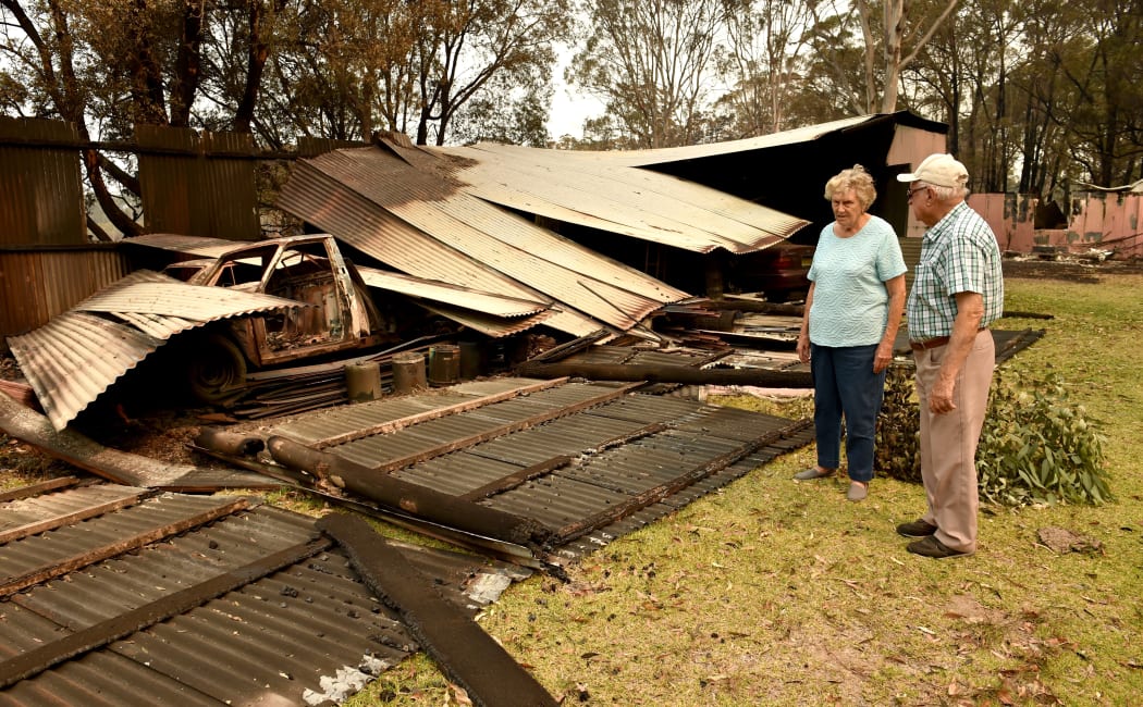 Art Murphy and his wife Shirley look at a burnt-out section of their property in Old Bar, 350km north of Sydney.