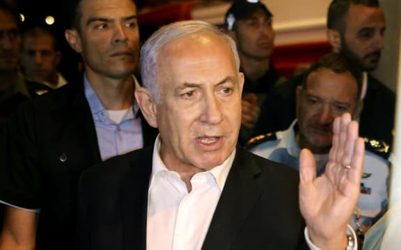 Israeli Prime Minister Benjamin Netanyahu tours the city of Lod early on May 12, 2021.