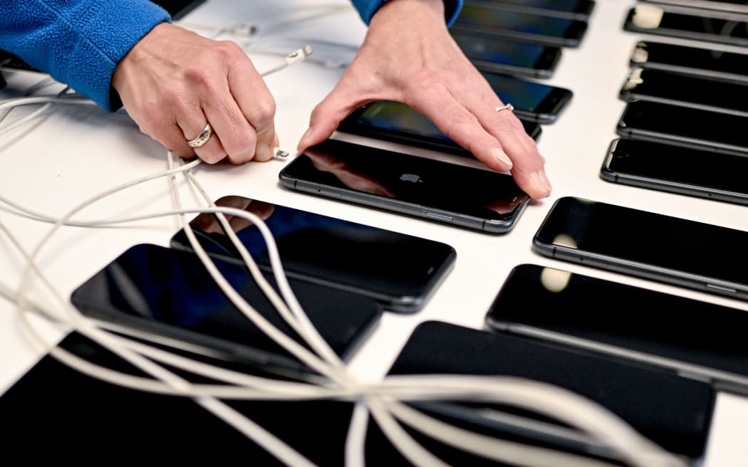 Ramona Köhler, a production employee, connects cell phones at Interzero Product Cycle, a facility for refurbishing electronic devices.