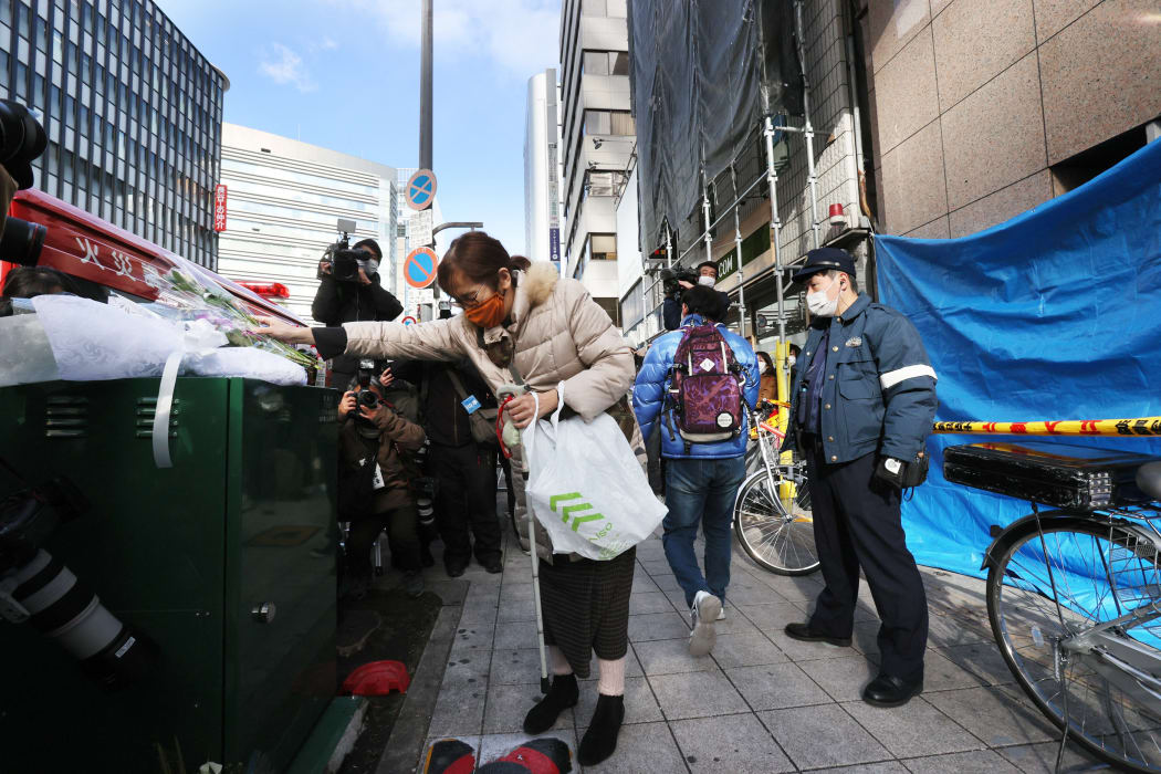 Flowers are offered in front of a fire site in Osaka City, Japan