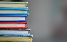 a stack of hardcover books