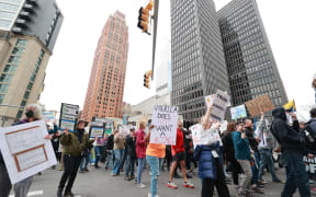 DETROIT ,MICHIGAN-APRIL 19:  Protesters march locally as part of the nationwide "Hands Off!" protest against US President Donald Trump and his administrarion in Detroit, Michigan USA, on Saturday, April 19, 2025. (Photo by Jorge Lemus/NurPhoto) (Photo by Jorge Lemus / NurPhoto / NurPhoto via AFP)