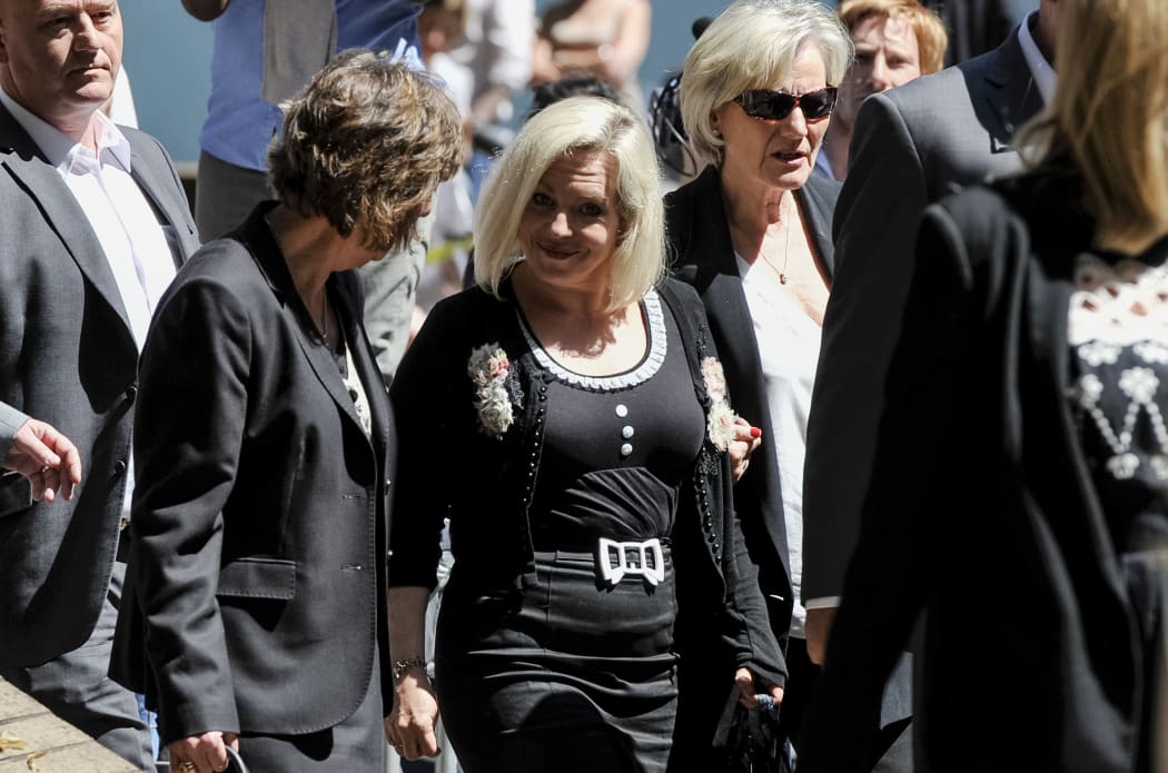 Daughter of veteran entertainer Rolf Harris, Bindi Harris (C) leaves Southwark Crown Court following her father's sentencing.