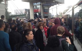 Hundreds of train commuters wait at Kingsland station after a fault caused widespread delays.