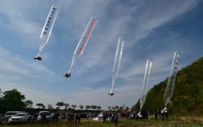 South Korean and US activists release balloons carrying anti-Pyongyang leaflets at a field near the Demilitarized zone dividing the two Koreas in the border city of Paju on 29 April, 2016.