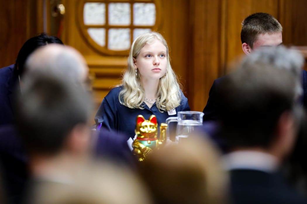 Julia Randerson looks skyward for inspiration as she collects telling points for her speech, the team mascot does likewise.