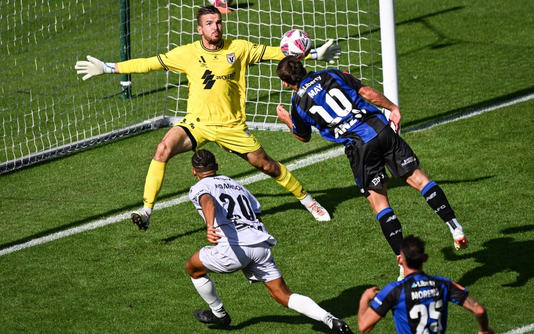 Guillermo Bartesaghi of Auckland FC heads the ball at goal as Filip Kuro of Macarthur FC reacts to make a save in their men’s A-League football match at Mt Smart Stadium, 1 Feb 2025.