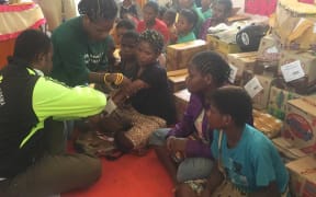 A volunteer doctor tends to a woman's broken arm, Wamena, Papua.