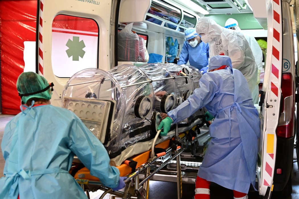 Medical staff transfer from the Garbagnate Milanaise hospital a patient with Covid-19 in a bio-containment stretcher for infectious diseases to Varese hospital.
