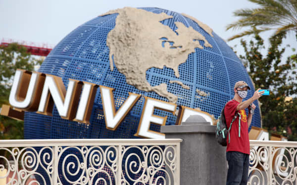 A visitor takes a selfie at Universal Studios theme park on the first day of reopening from the coronavirus pandemic, on June 5, 2020, in Orlando, Florida. (Photo by Gregg Newton / AFP)