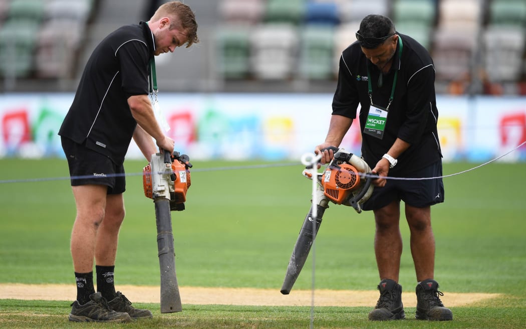 Ground staff try to dry the wicket block, McLean Park, Napier.