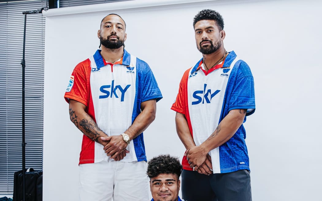 Ardie Savea, right, Pone Fa’amausili,left, and Lotu Inisi, sitting front, display the new Moana Pasifika heritage jersey, a replica of the old Pacific Islanders jersey. Photo: Moana Pasifika