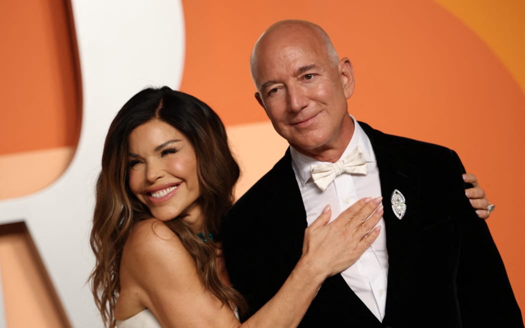 CEO of Amazon Jeff Bezos and partner Lauren Sanchez attend the Vanity Fair Oscar Party at the Wallis Annenberg Center for the Performing Arts in Beverly Hills, California, on March 2, 2025. (Photo by Michael Tran / AFP)
