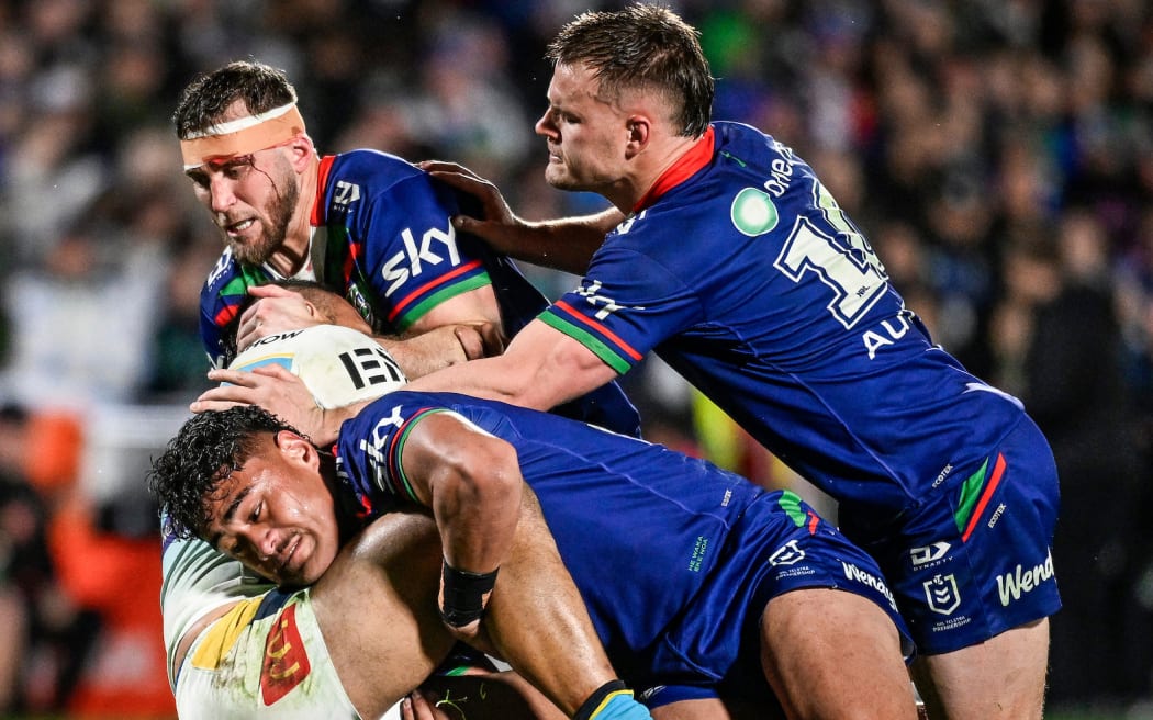 Phillip Sami of the Titans is tackled by Jacob Laban, Kurt Capewell and Jackson Ford of the Warriors, NZ Warriors v Gold Coast Titans.