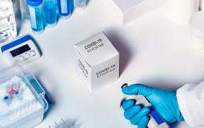 Novel coronavirus 2019 nCoV pcr diagnostics kit. Hand in glove with automatic pilette. RT-PCR kit to detect 2019-nCoV or covid19 virus in clinical samples.