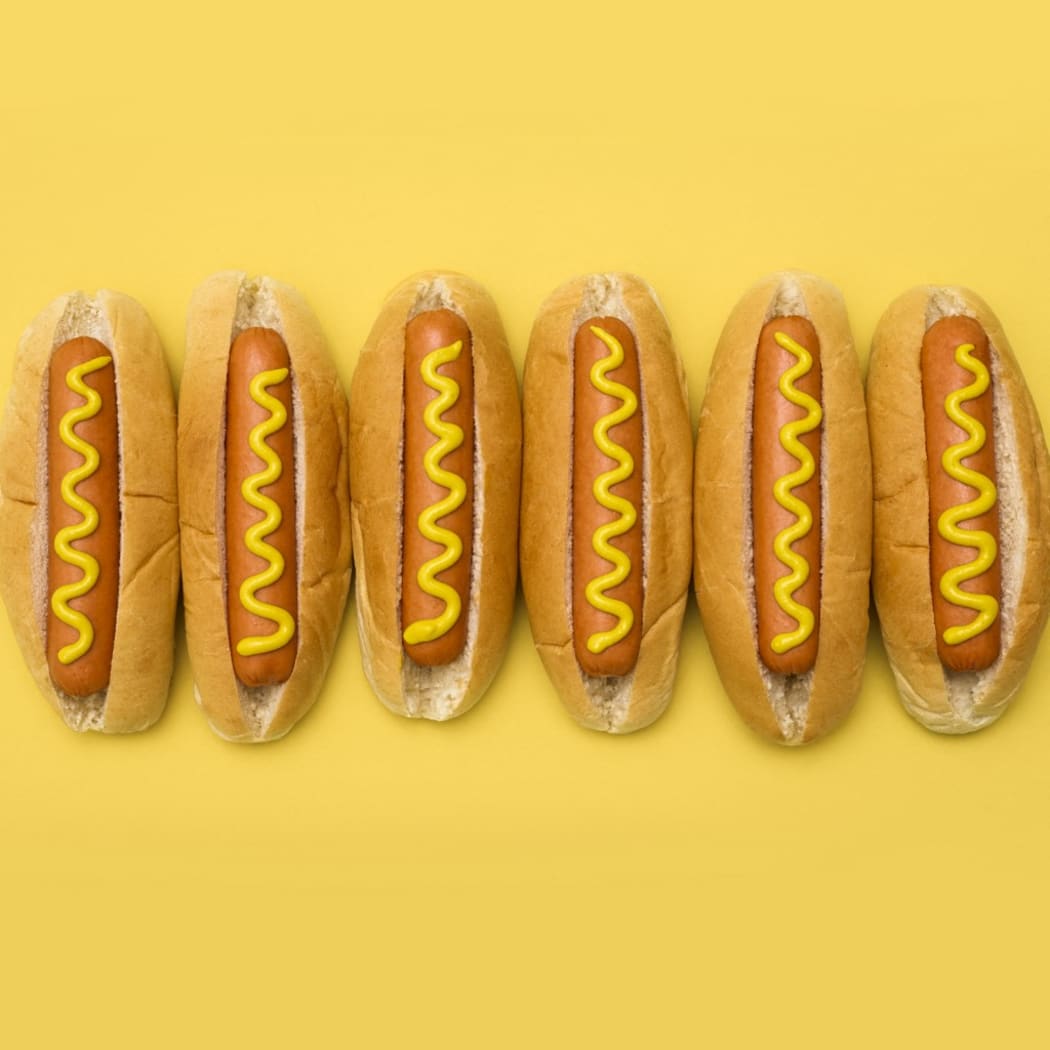 Hot dogs against a plain background. (Photo by SCIENCE PHOTO LIBRARY / R3F / Science Photo Library via AFP)