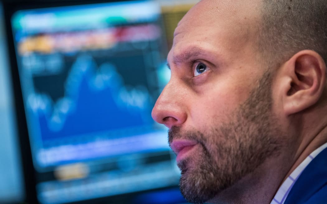 A trader works on the floor of the New York Stock Exchange.