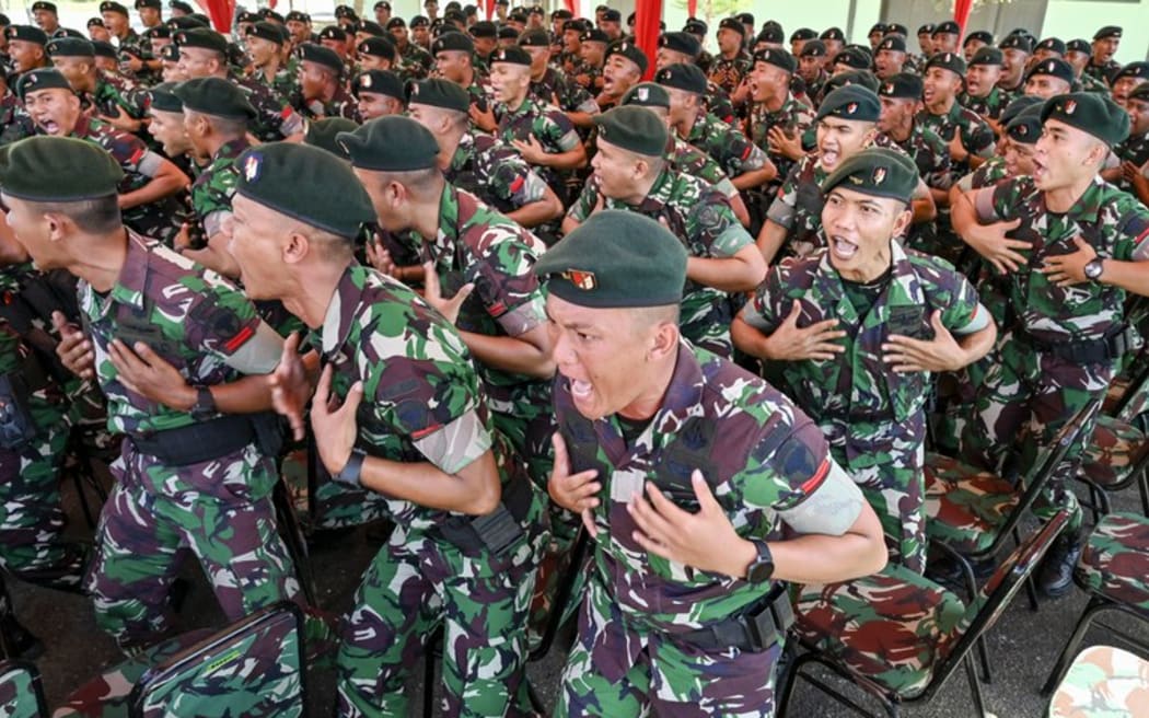 Soldiers from the Indonesian Army's 112th Raider Infantry Battalion sing during a ceremony at a military base in Japakeh, Aceh province on June 25, 2024, ahead of their deployment to Papua province. [Chaideer Mahyuddin/AFP]