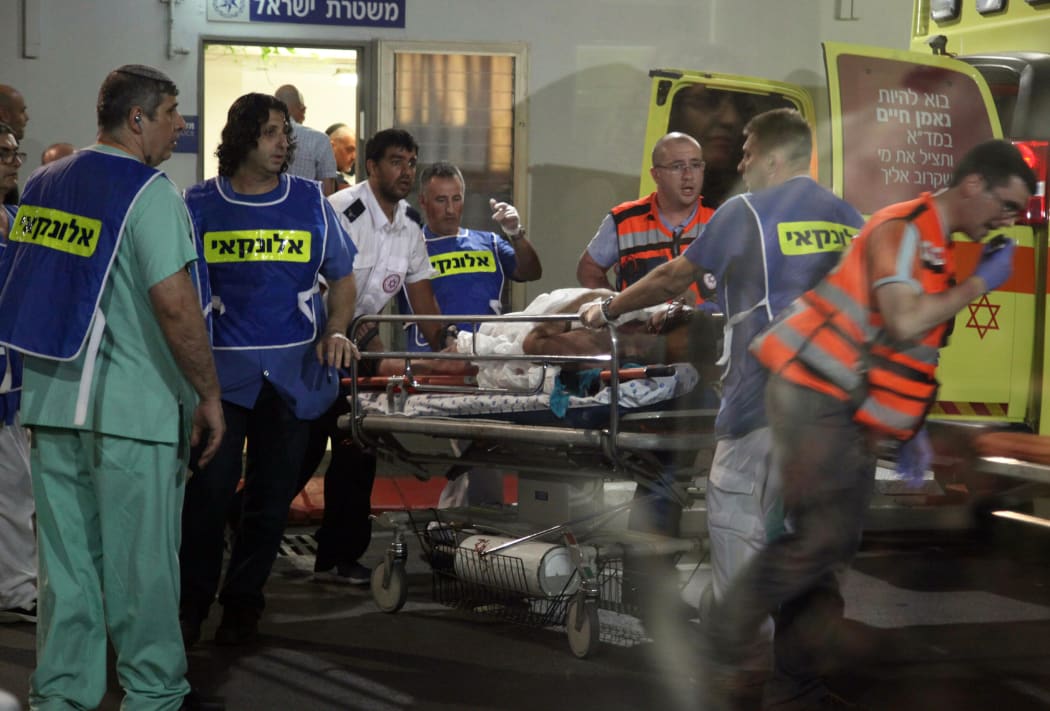 Israeli medics arrive with an injured person at a hospital a few moments after the shooting attack.