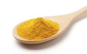 Ground turmeric (Curcuma longa) on a wooden kitchen spoon. (Photo by PHOTOSTOCK-ISRAEL/SCIENCE PHOTO / PSI / Science Photo Library via AFP)