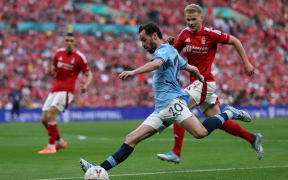 Manchester City's Portuguese midfielder #20 Bernardo Silva crosses the ball during the English FA Cup semi-final football match between Nottingham Forest and Manchester City at Wembley Stadium in north London on April 27, 2025. (Photo by Adrian Dennis / AFP) / NOT FOR MARKETING OR ADVERTISING USE / RESTRICTED TO EDITORIAL USE