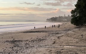Despite warnings, people were out on Takapuna Beach on Thursday morning.