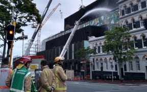 A crane has been brought in to help put out the fire.
