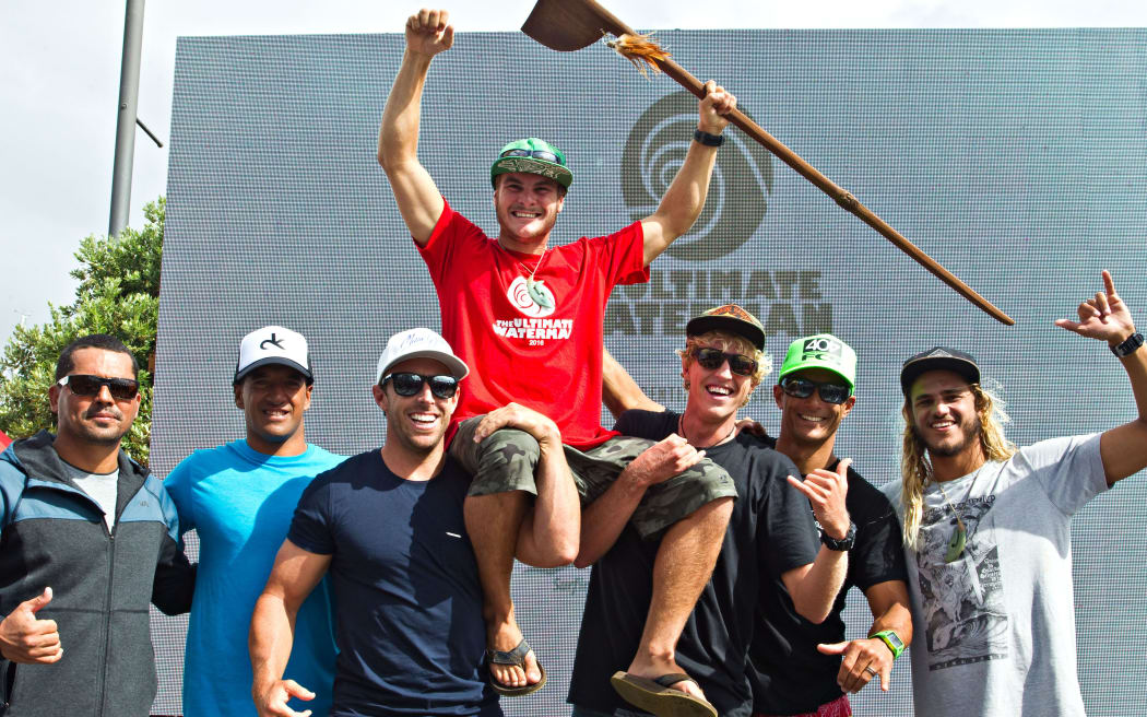 Ultimate Waterman competitors raise the 2016 champion Zane Schweitzer.