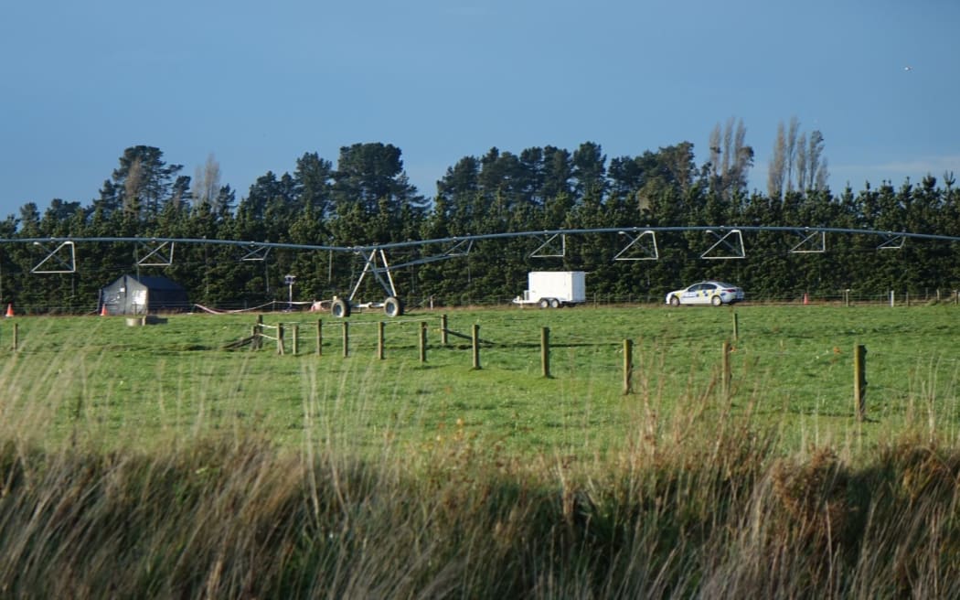 Police near the scene where the body was found on the banks of the Rakaia River.