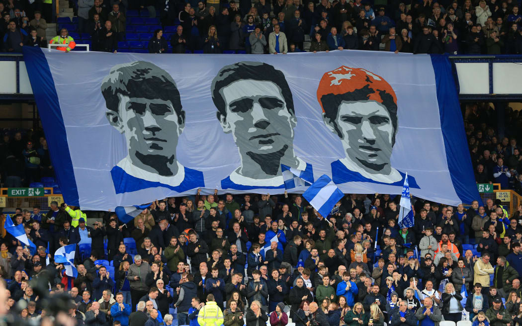 Everton fans display a giant banner of  the  "Holy Trinity" featuring former players Howard Kendall, Colin Harvey and Alan Ball