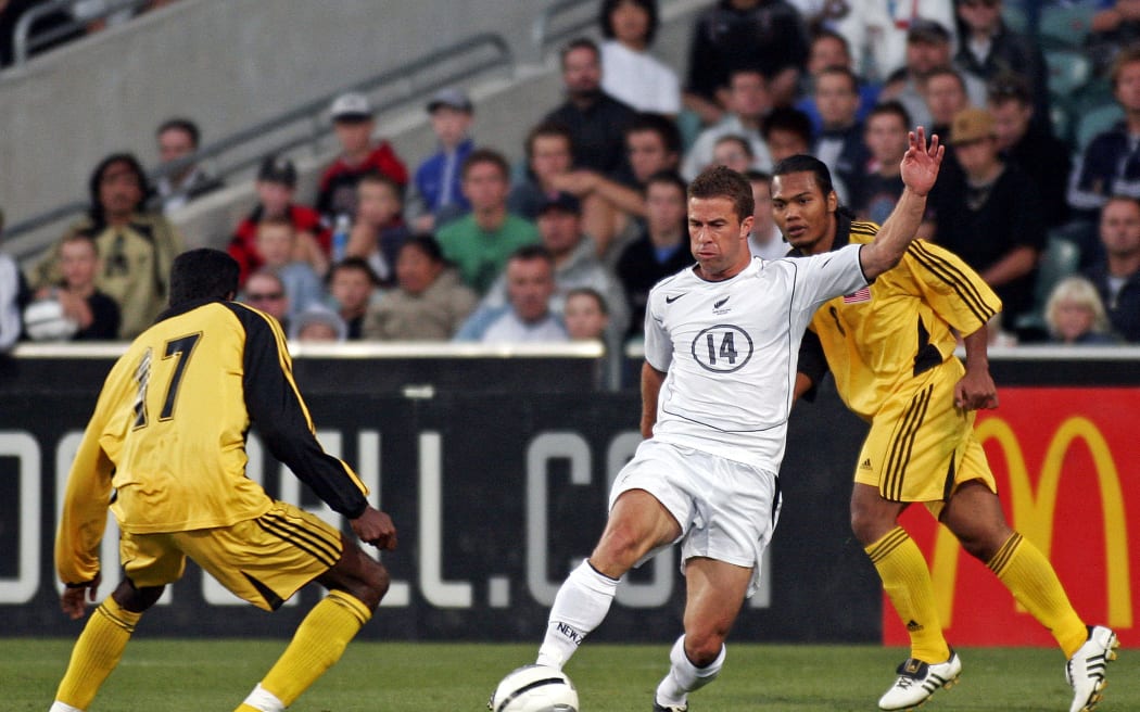 All Whites' fullback Noah Hickey looks to take on Malaysia's Nanthakumar Lkalliappan (l) during the 2nd international friendly match between the New Zealand All Whites and Malaysia at North Harbour Stadium, Auckland on Thursday 23 February 2006.