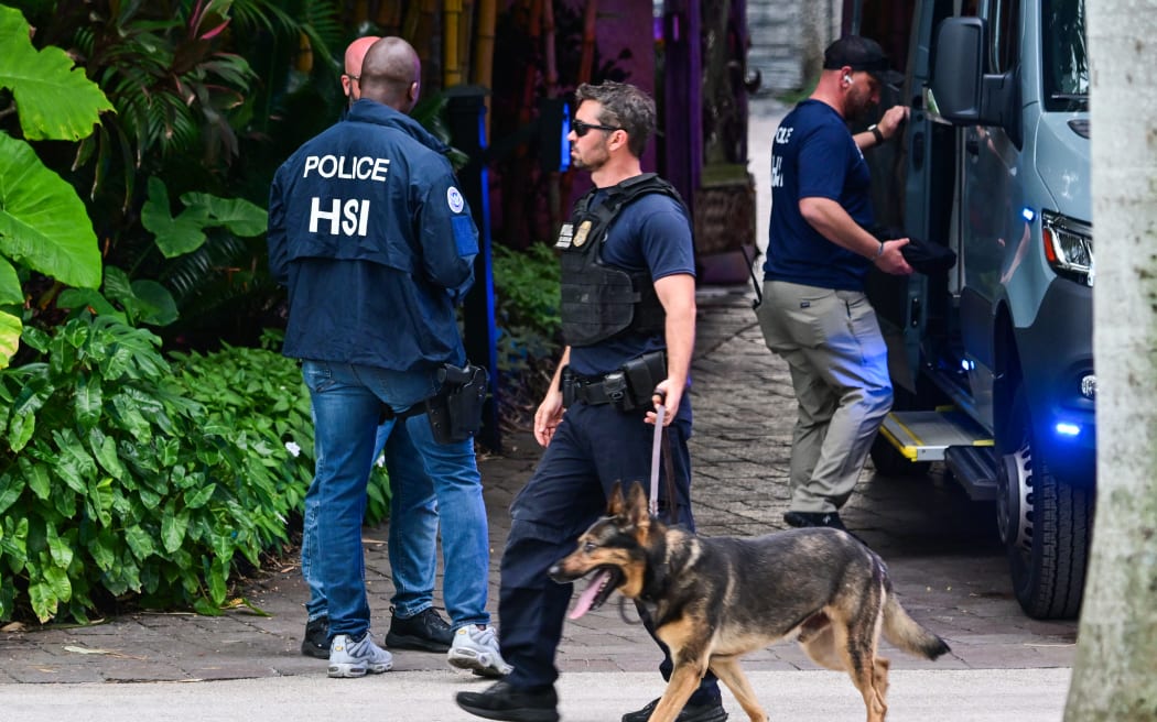 Federal and Homeland Security Investigation agents are seen at the entrance of US producer and musician Sean "Diddy" Combs's home at Star Island in Miami Beach on March 25, 2024. Homes belonging to Sean "Diddy" Combs were being raided by federal agents, media reported on March 25, with the US hip hop mogul at the center of sex trafficking and sex assault lawsuits. (Photo by GIORGIO VIERA / AFP)