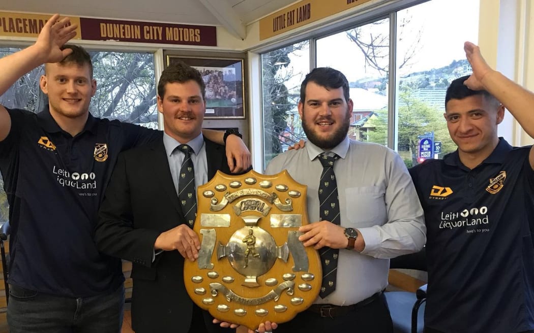 Dunedin Rugby Club players with the Charity Shield.