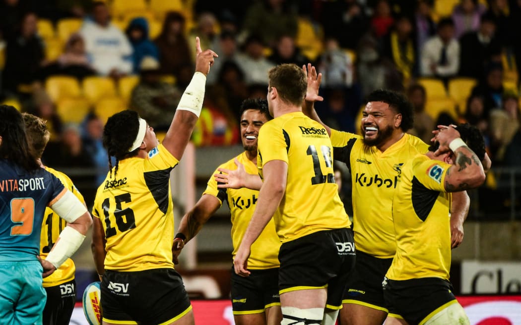 Raymond Tuputupu of the Hurricanes celebrates his try.