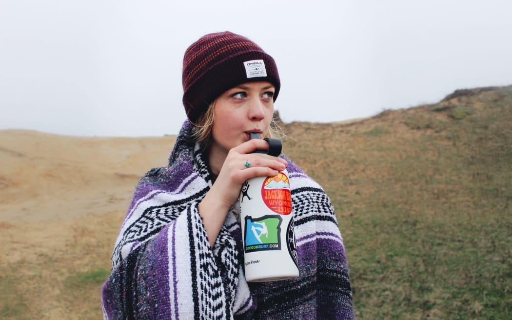 girl drinking from water bottle