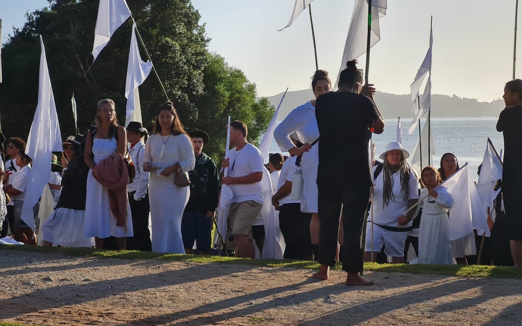 Tame Iti has arrived at Te Whare Rūnanga this morning with a large contingent of activists carrying white flags of great height as part of an art installation.
