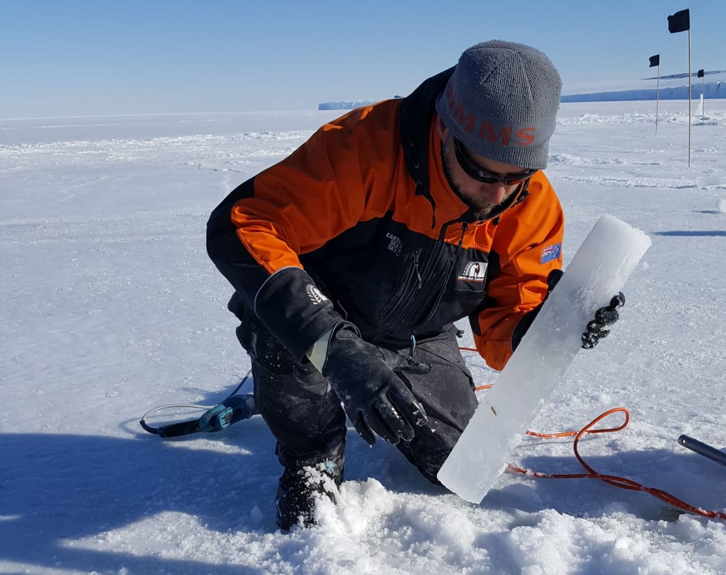 Klaus Meiners, from Australian Antarctic Division, holds a sea ice core.